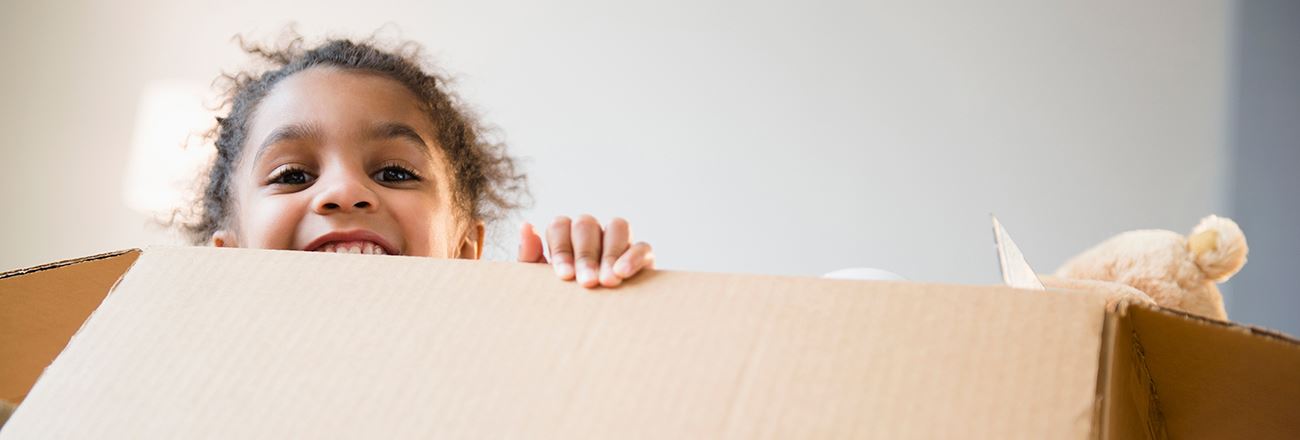 kid with a large moving box