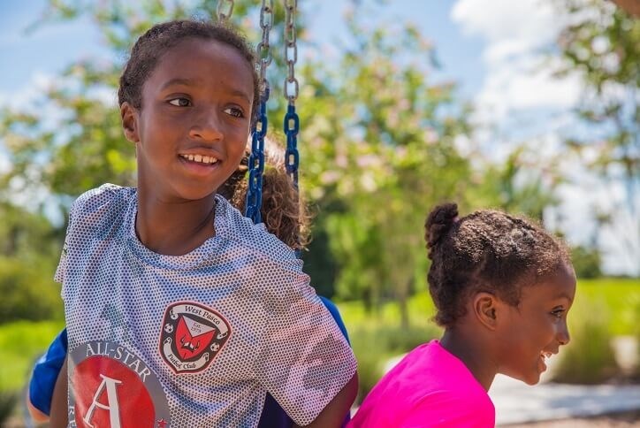 Bexley kid residents on tire swing at Game On Park in Bexley