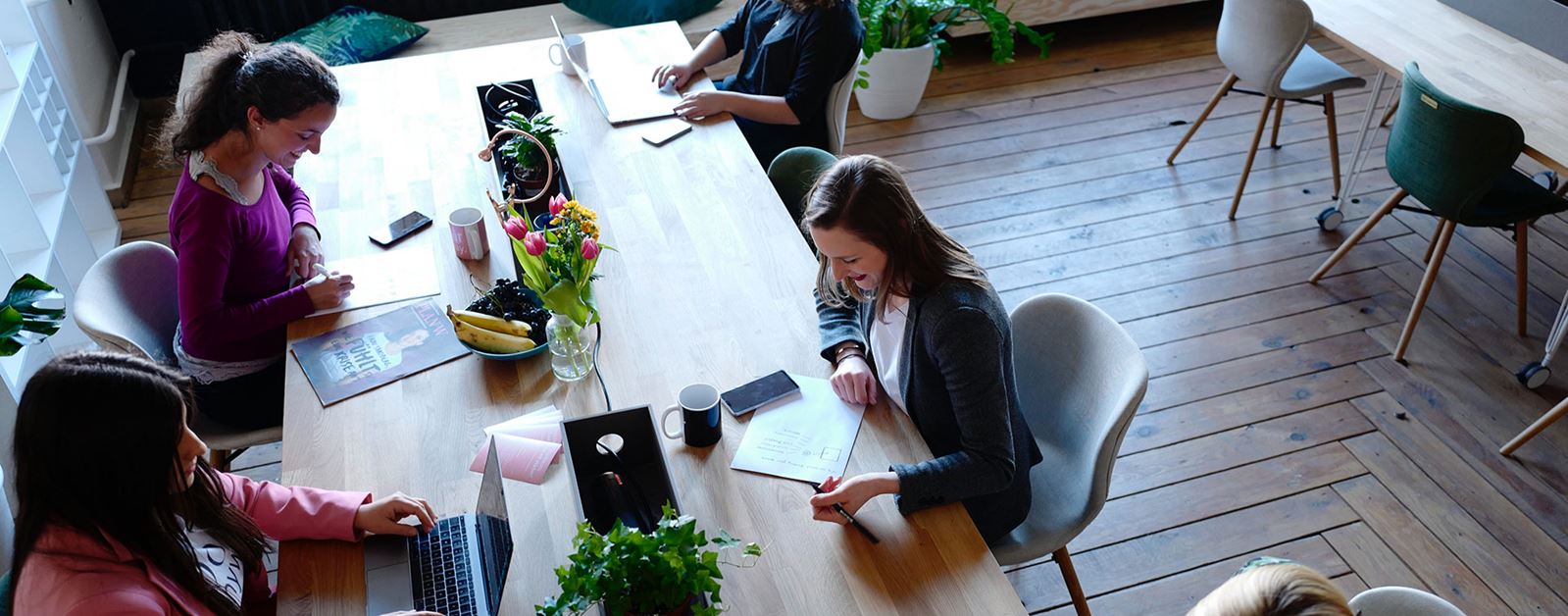 Women working together at large open table.